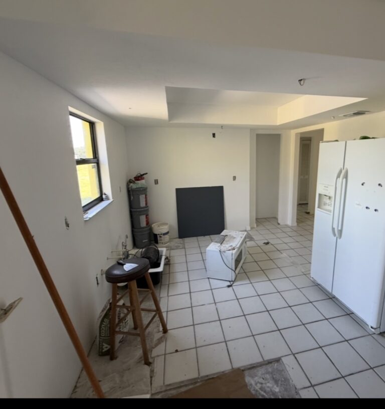 Kitchen with cabinets removed during an unfinished renovation